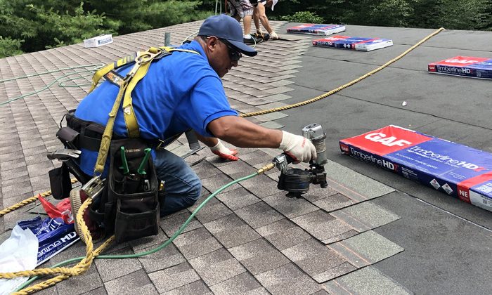 Roof Installation Westchester County NY Roof installation in Westchester County NY - B&W Group roofer nailing down GAF Timberline shingles